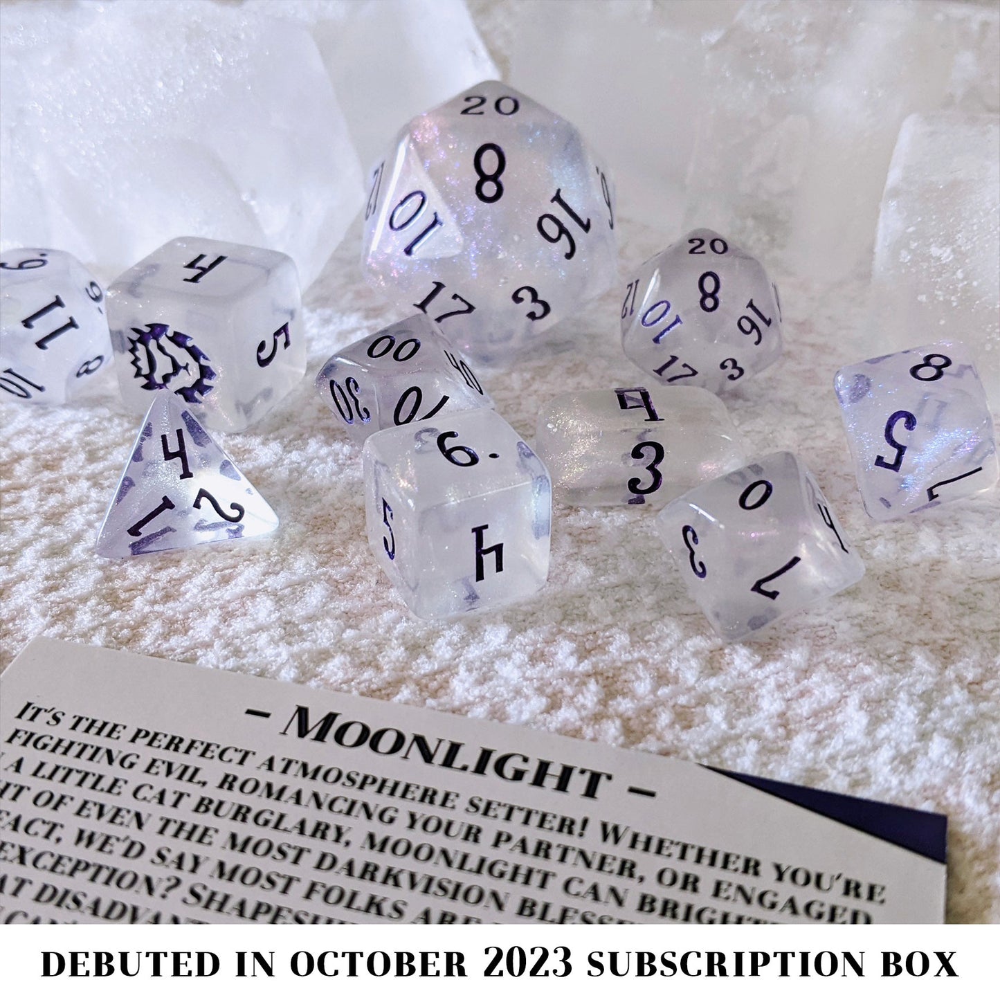 Moonlight is a 10-piece set of clear acrylic dice, filled with purple-blue colorshifting microglitter and inked in dark purple.