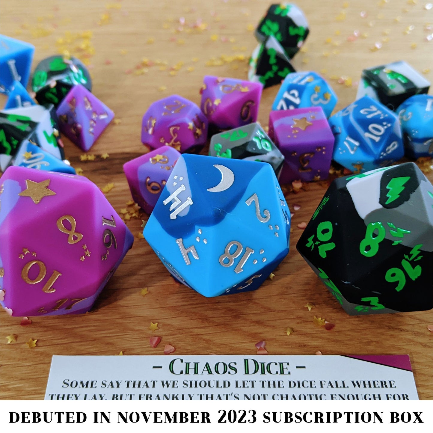 Chaotic Neutral is an 8-piece, swirled silicone dice set in bright blues and greys. It features a moonlit silver ink design.