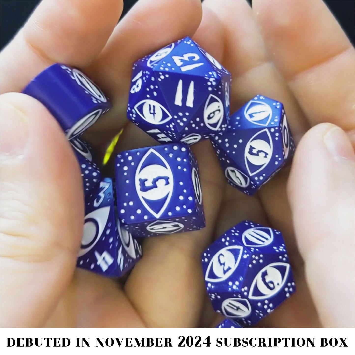 Cruel Observer is an 8-piece Dice Envy Exclusive metal set in matte indigo with white ink, featuring an original design by our in-house artists!