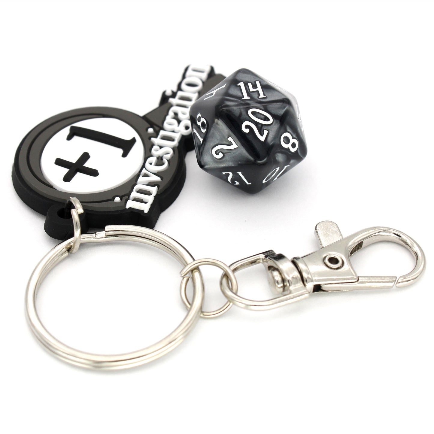 Investigation Keychains come with a key ring and metal clasp attached to a roughly 2.5" rubber magnifying glass. Designed in-house by Dylan after someone made a silly joke.