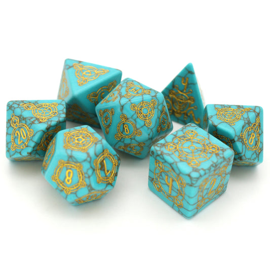 Oasis is a 7-piece set of dice cut from lab-made turquoise, engraved with Dice Envy's exclusive Sigil design and inked in gold.