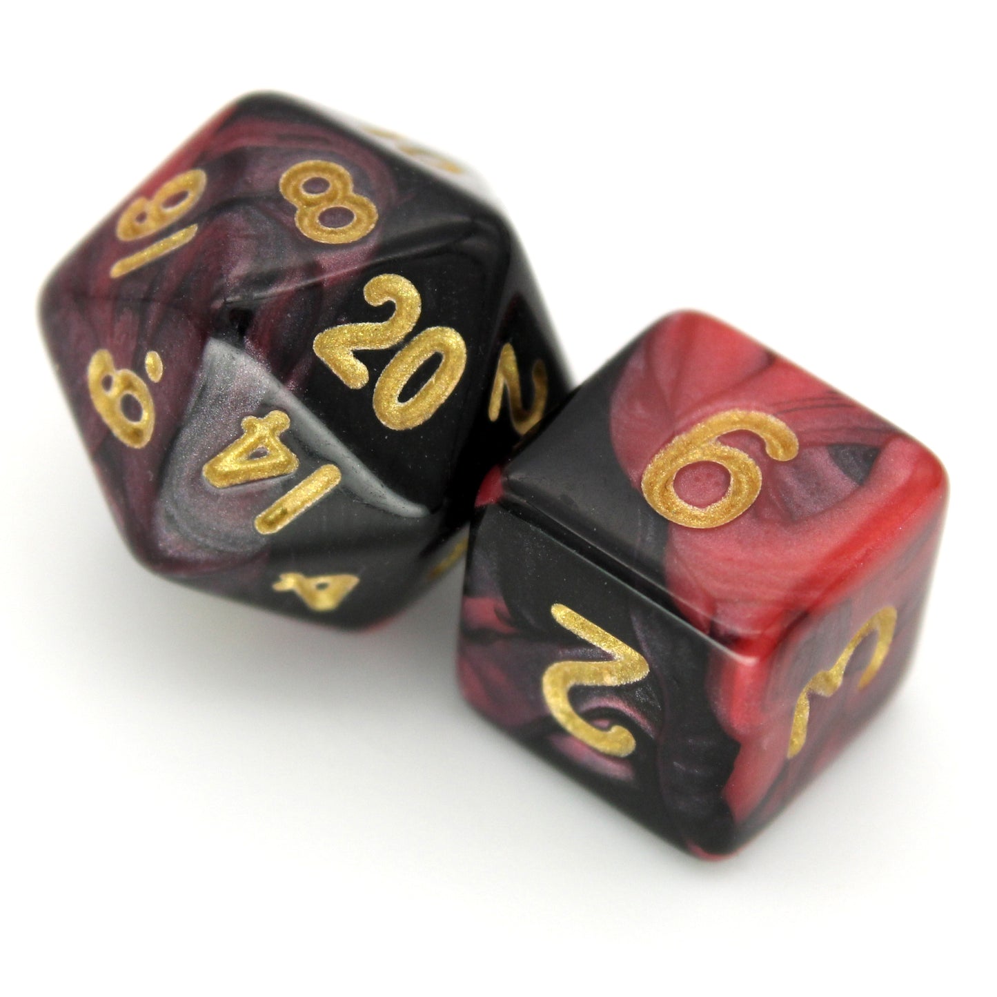 D'monic is a 7-piece 13mm resin dice set with swirls of black and red, inked in gold. It belongs to our tiny but mighty Wee Lads collection.