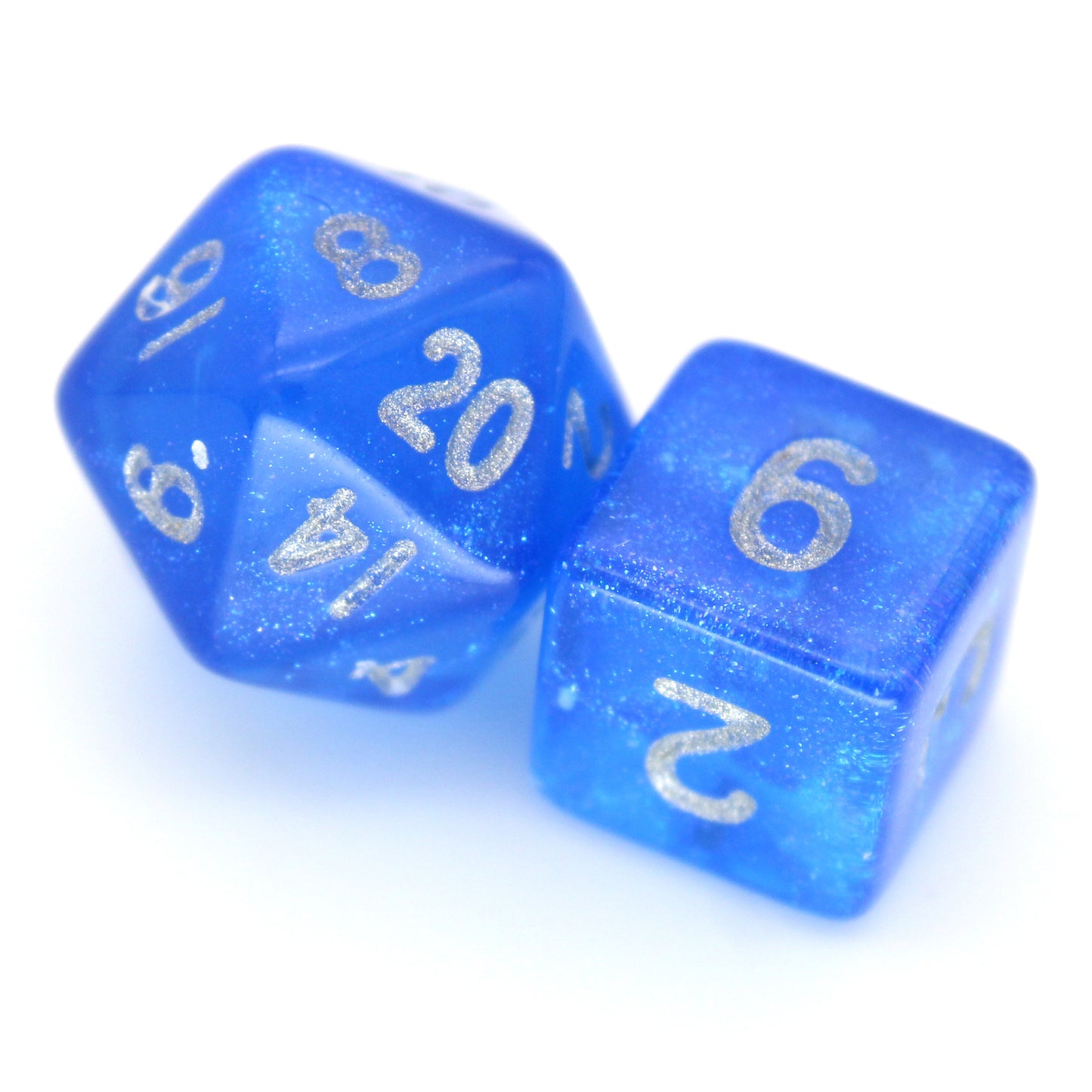 Sapphyre is a 7-piece 13mm semi-translucent glittery blue resin dice set, inked in silver. It belongs to our tiny but mighty Wee Lads collection.