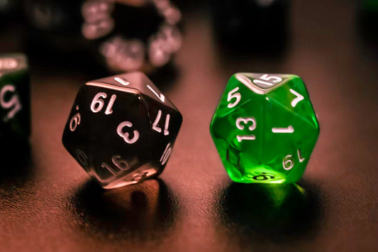 black and green dice on a table