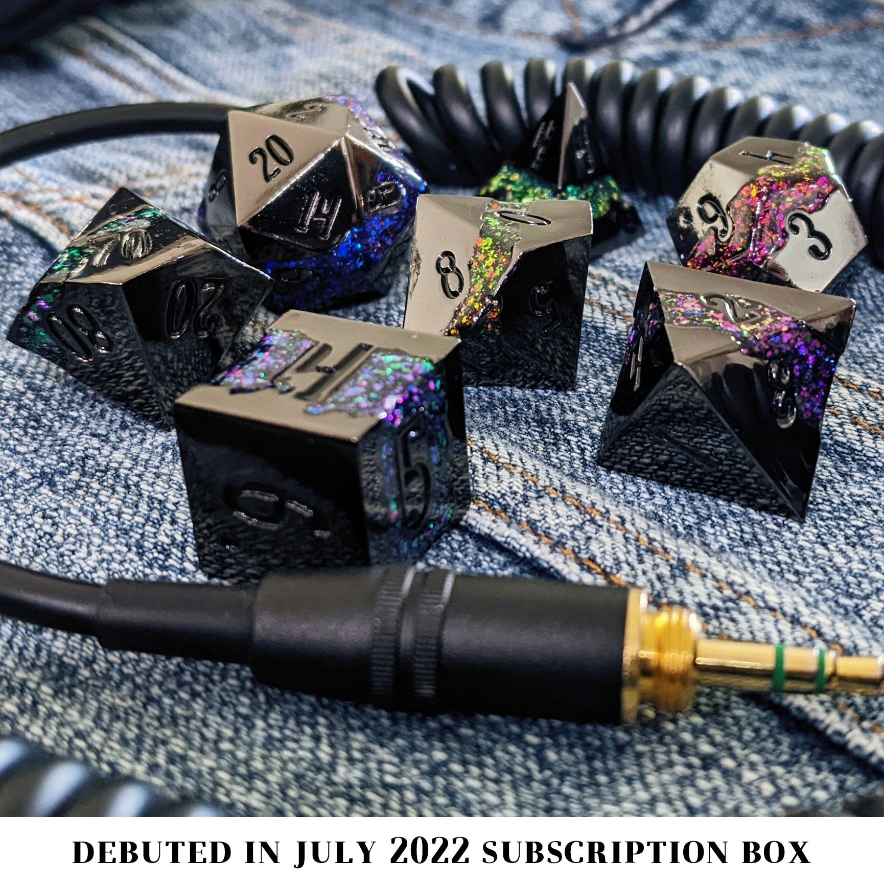 Slightly larger than our usual offerings, this metal 7-piece set is cold in your hold, the frames black like the shadow of the night, while each die has one of the colors of the rainbow set into it in glittering, vibrant enamel.
