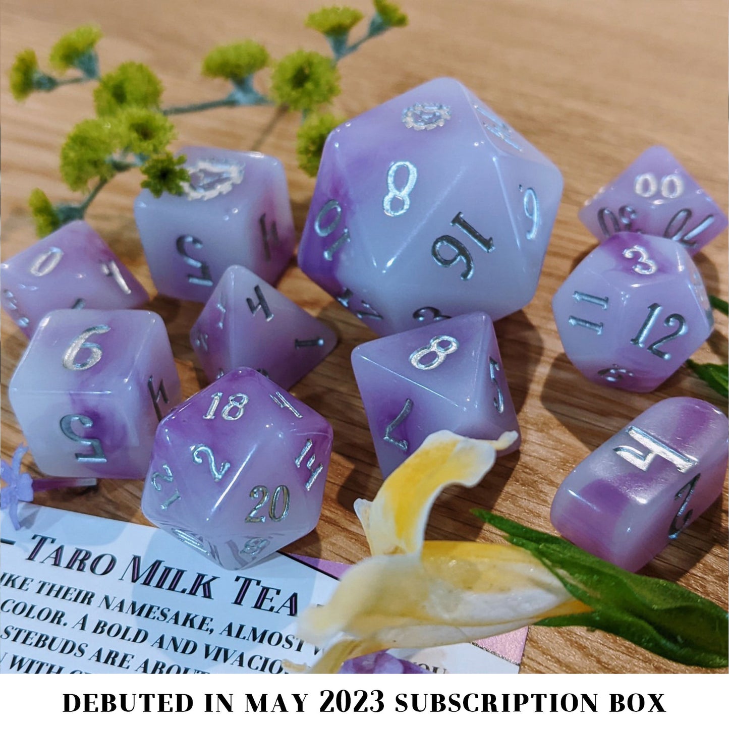 Taro Milk Tea is a 10-piece purple and white swirled resin dice set inked in silver.