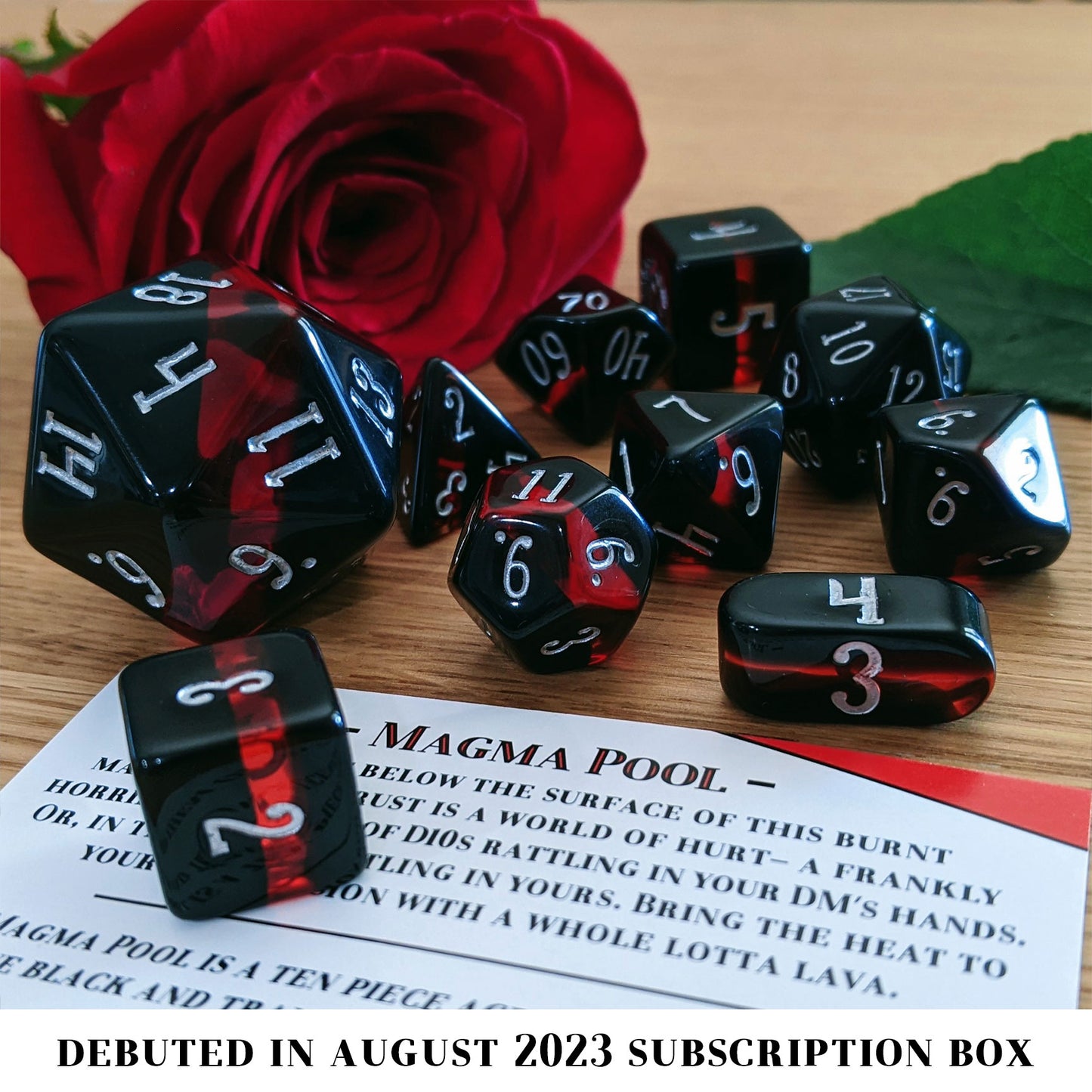 Magma Pool is a 10-piece set of layered resin dice in opaque black and translucent red, inked in silver.