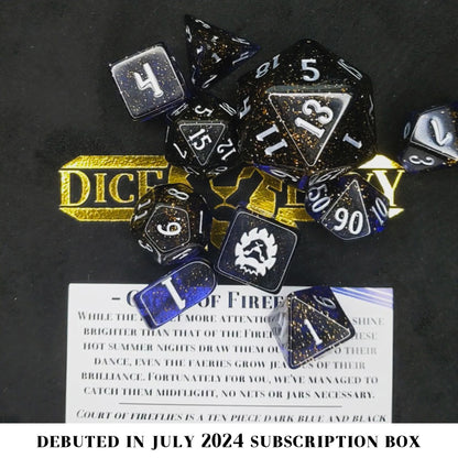 Court of Fireflies is a 10-piece, dark blue and black set of resin dice filled with gold glitter and inked in starry silver.