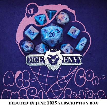 Accursed Confections is a 10-piece set of swirled acrylic dice in sugary blue, pink, purple, and white with dark purple ink.