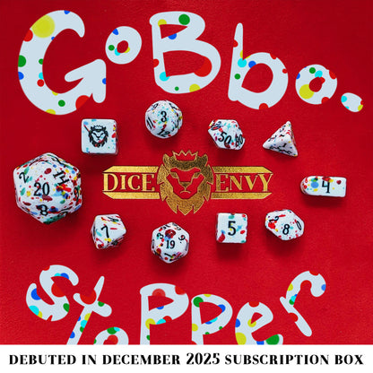 Gobbostopper is a 10-piece white acrylic set with black ink and red, blue, yellow, and green splatters. Please do not eat the dice, goblin or not!