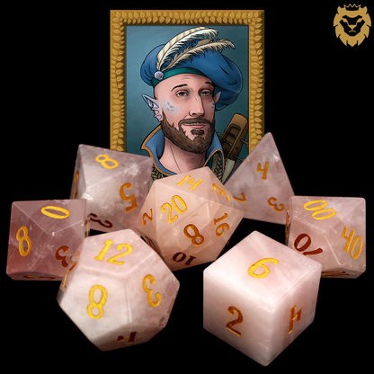 La Vie En Rose is a 7-piece set of rose quartz dice with gold numbering.