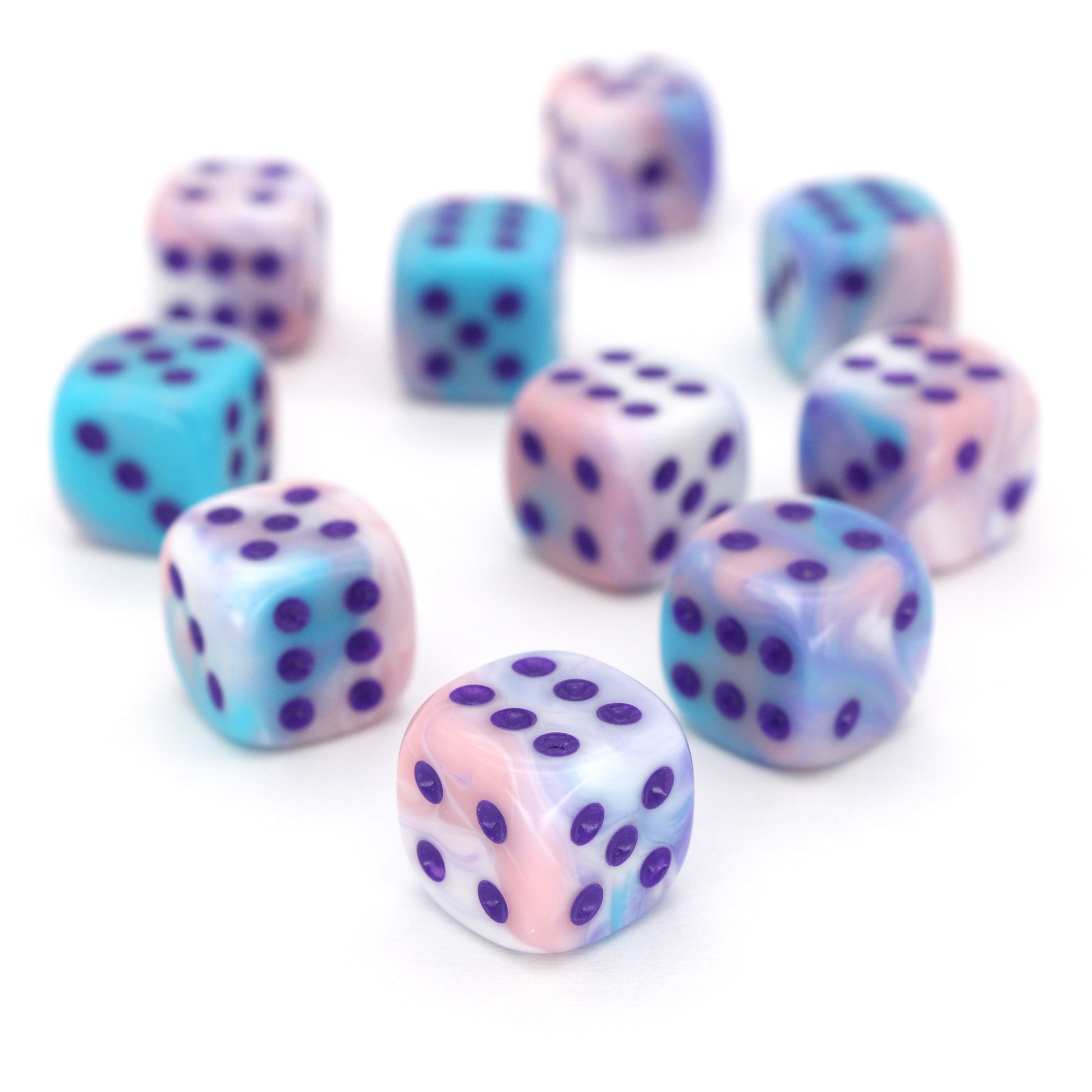 Accursed Confections is a 10-piece set of swirled acrylic 12mm d6 in sugary blue, pink, purple, and white with dark purple ink.