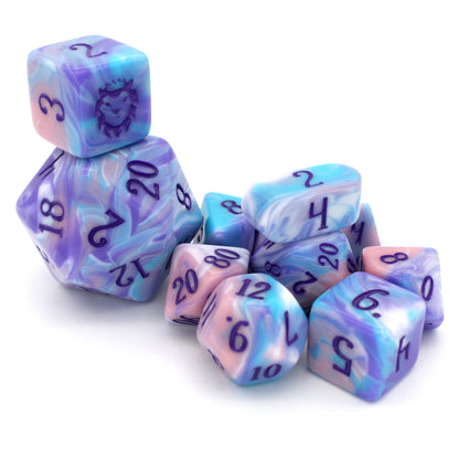 Accursed Confections is a 10-piece set of swirled acrylic dice in sugary blue, pink, purple, and white with dark purple ink.