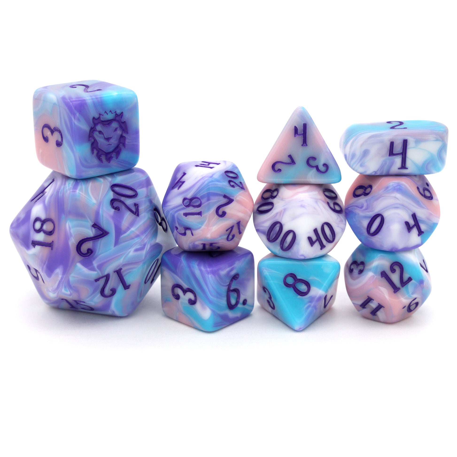 Accursed Confections is a 10-piece set of swirled acrylic dice in sugary blue, pink, purple, and white with dark purple ink.