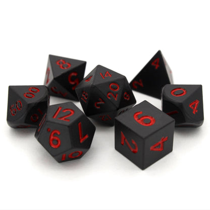 Bloodsuckers is a 7-piece set of matte, black colored 10mm metal dice with bright red inking.