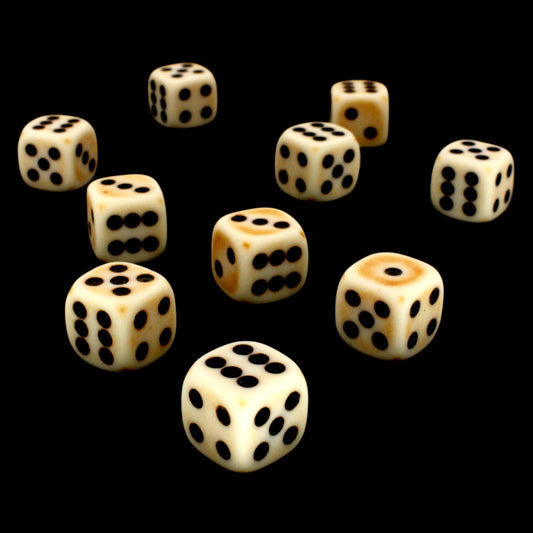 Crag Cat Claw is a 10-piece set of matte pale-colored 12mm d6s, with a natural patina, and pips inked in black.