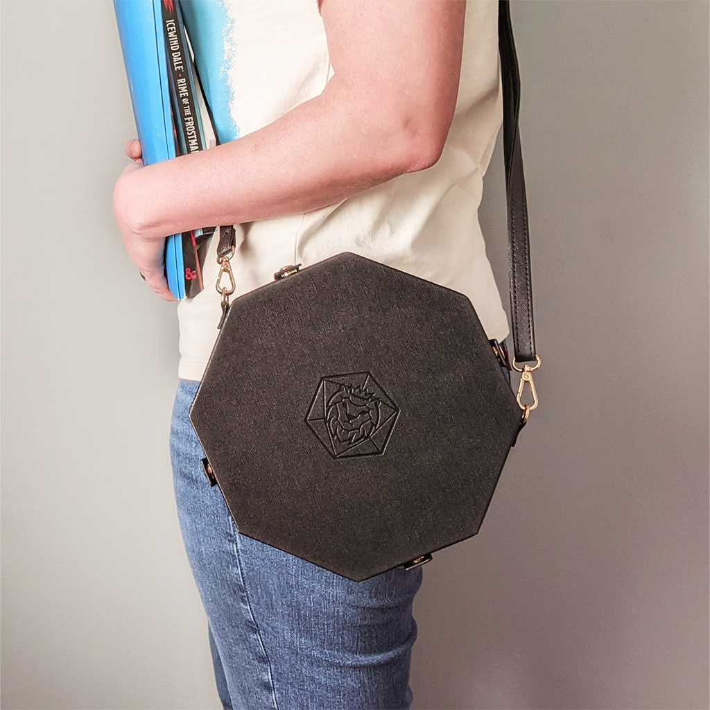 Made of black vegan leather and velvet, our Crossbody Dice Trays are deep enough to hold our Chonky d20s and have a removable strap that adjusts from 38" to 70" long.