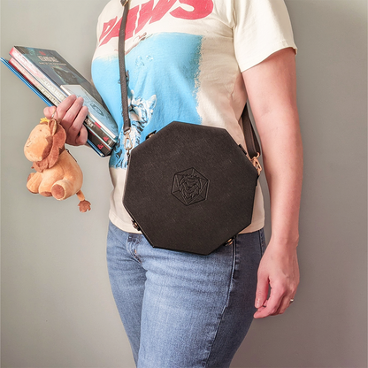 Made of black vegan leather and velvet, our Crossbody Dice Trays are deep enough to hold our Chonky d20s and have a removable strap that adjusts from 38" to 70" long.