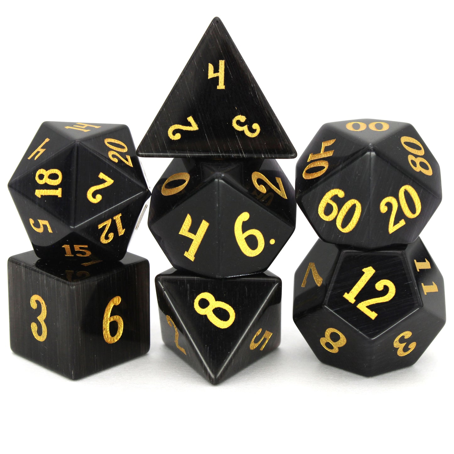 Dark Night is a 7-piece set of black, cat's eye glass dice with gold numbering.