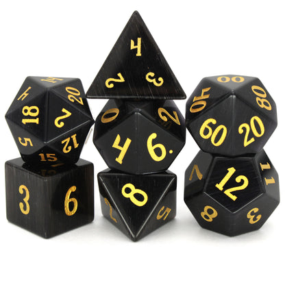 Dark Night is a 7-piece set of black, cat's eye glass dice with gold numbering.
