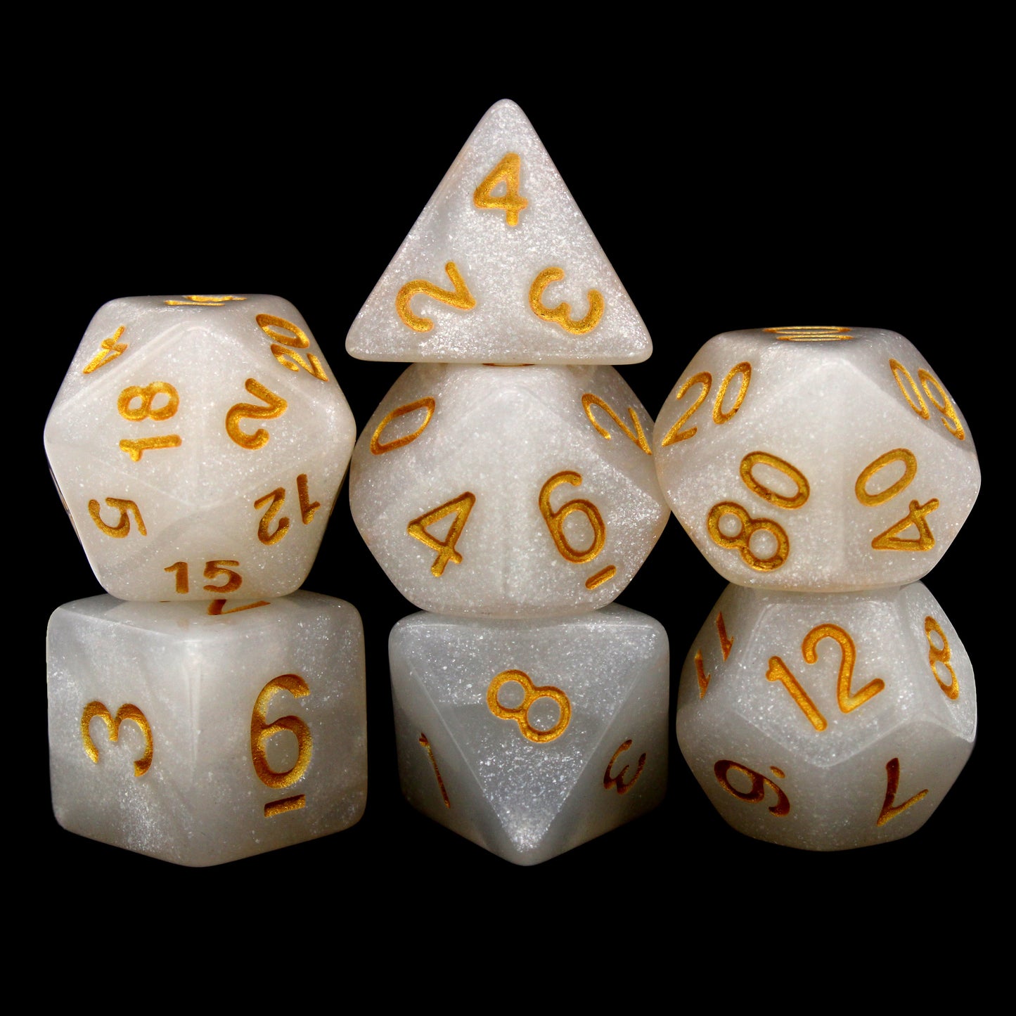 Djinni Dust is a 7-piece set of pale white, glittery dice, inked in vibrant gold.
