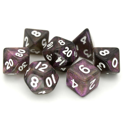 Grapeful Dead is a 7-piece, 13mm, black resin dice set shimmering with violet glitter and inked in white.