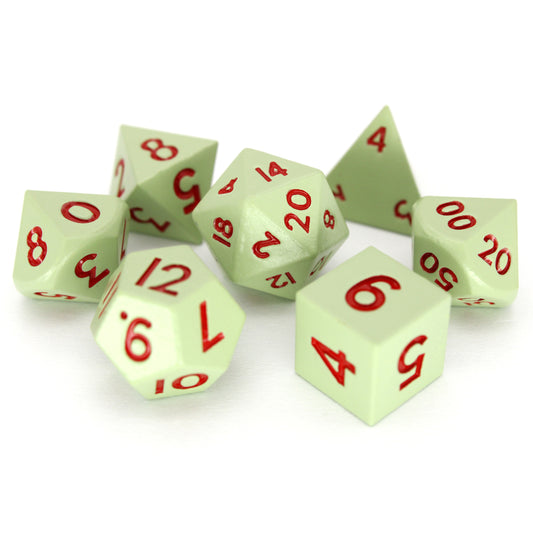Gremlins is a 7-piece set of matte, pale-green colored 10mm metal dice with magenta inking.