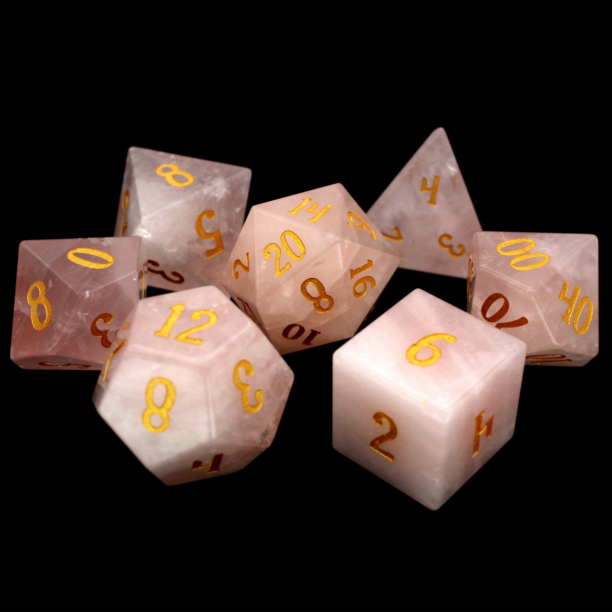 La Vie En Rose is a 7-piece set of rose quartz dice with gold numbering.