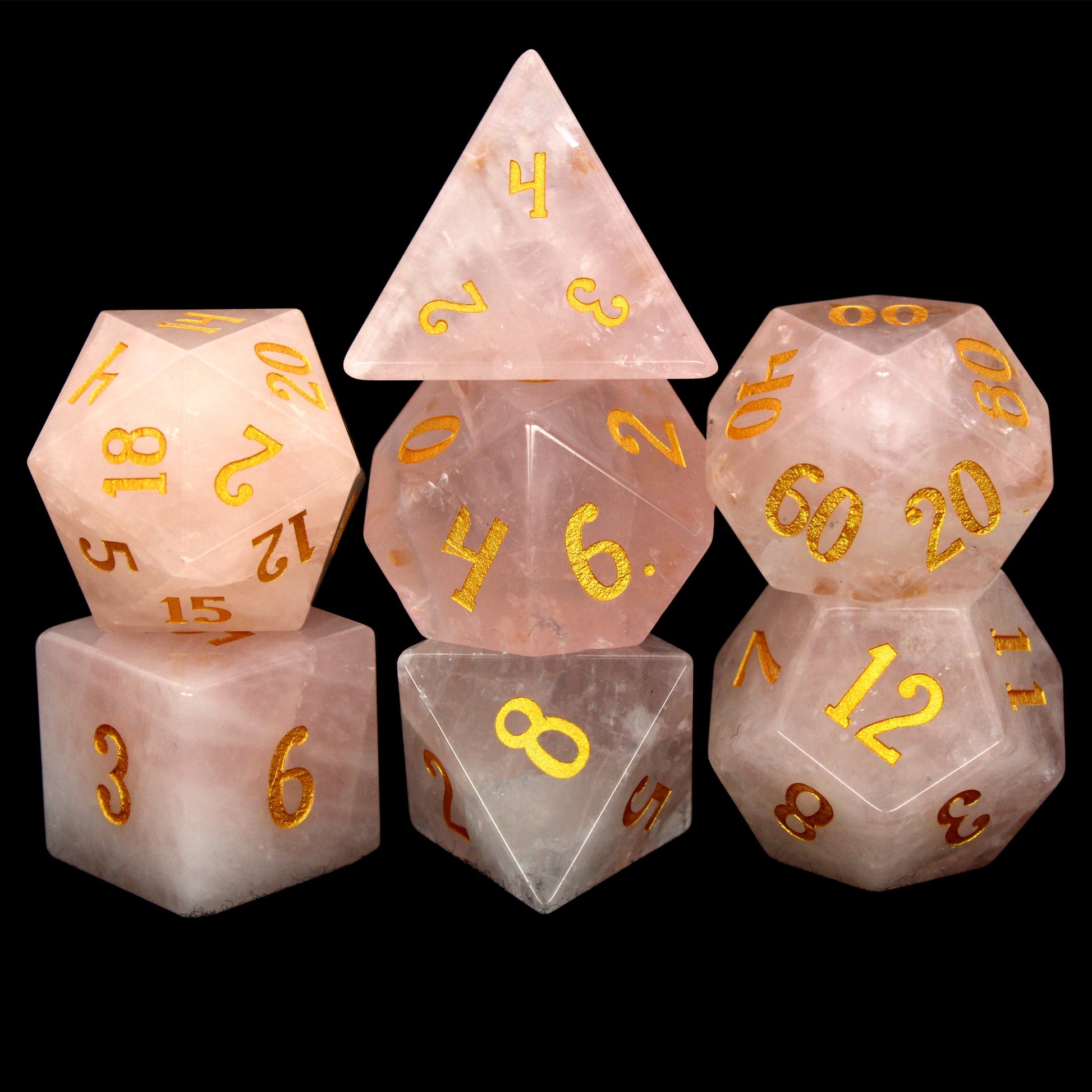 La Vie En Rose is a 7-piece set of rose quartz dice with gold numbering.