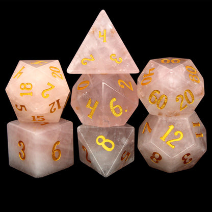 La Vie En Rose is a 7-piece set of rose quartz dice with gold numbering.