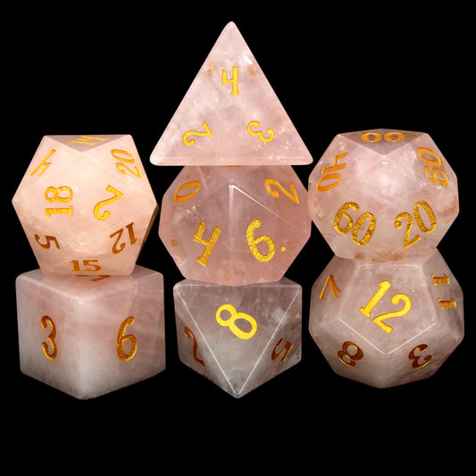 La Vie En Rose is a 7-piece set of rose quartz dice with gold numbering.