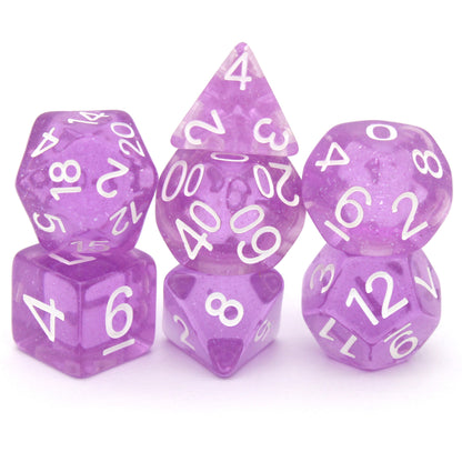 Lilactivity is a 7-piece, 13mm polymer set of transparent purple resin dice, shimmering with silvery glitter and inked in bright white. It belongs to our tiny but mighty Wee Lads collection. Standard d20 pictured for scale.