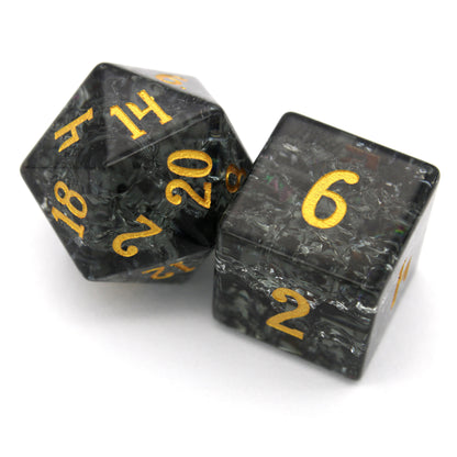 Midnight Sparkle is a 7-piece set of navy gray crystal dice with a crackle effect and gold numbering.