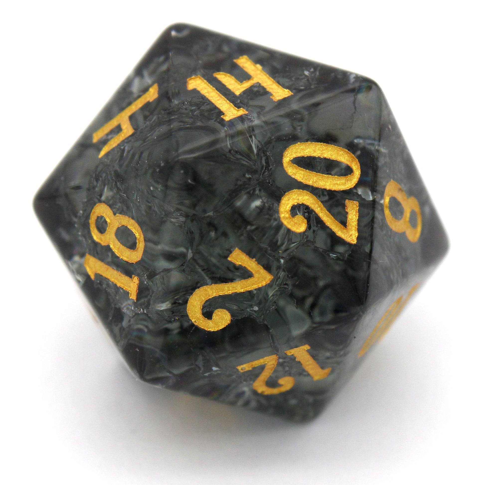 Midnight Sparkle is a 7-piece set of navy gray crystal dice with a crackle effect and gold numbering.
