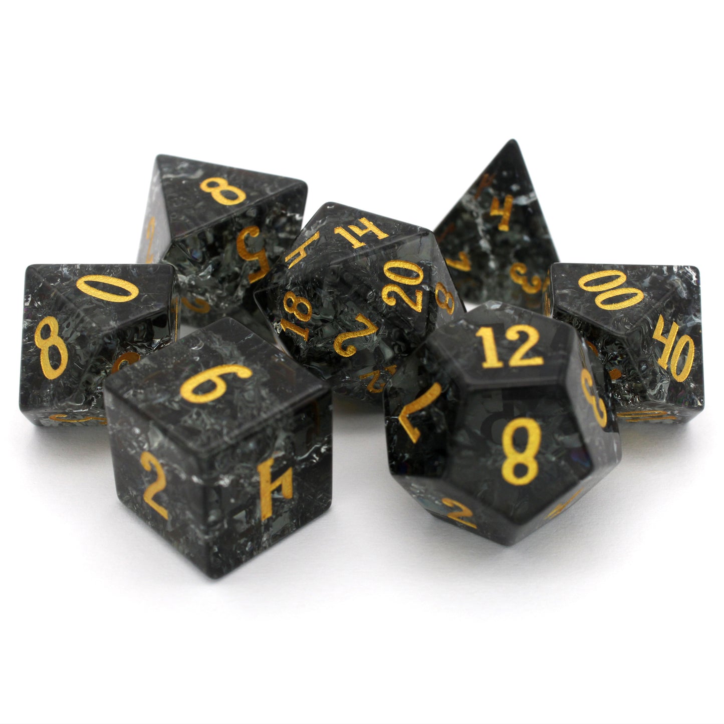 Midnight Sparkle is a 7-piece set of navy gray crystal dice with a crackle effect and gold numbering.