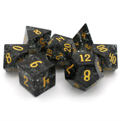 Midnight Sparkle is a 7-piece set of navy gray crystal dice with a crackle effect and gold numbering.