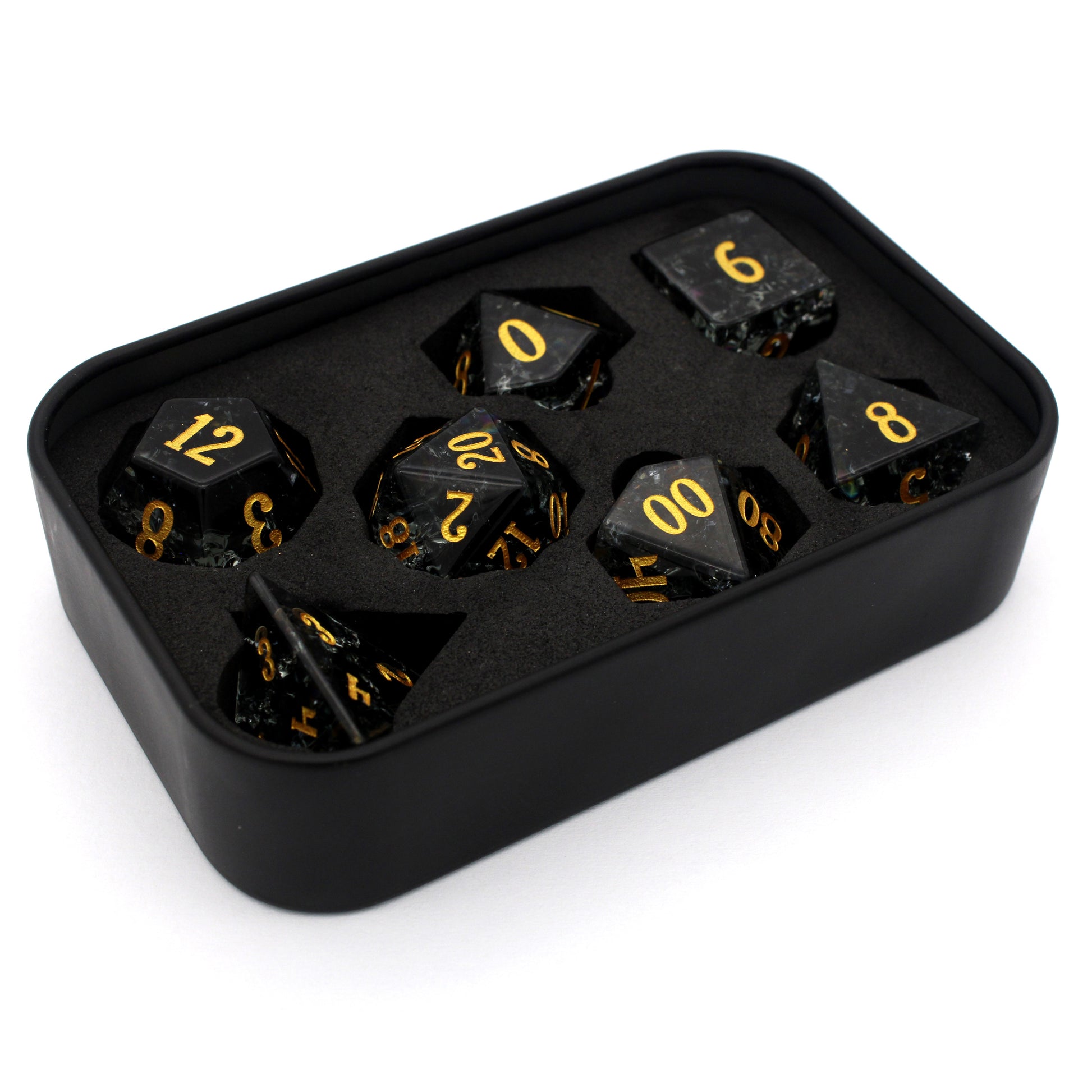 Midnight Sparkle is a 7-piece set of navy gray crystal dice with a crackle effect and gold numbering.