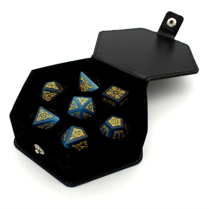 Midsummer's Eve is a 7-piece set of dice cut from blue, lab-made chatoyant stone, engraved with Dice Envy's exclusive Sigil design and inked in gold.