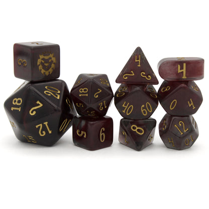 Old Blood is a 10-piece set of black and burgundy-swirled acrylic dice, inked in aged gold.