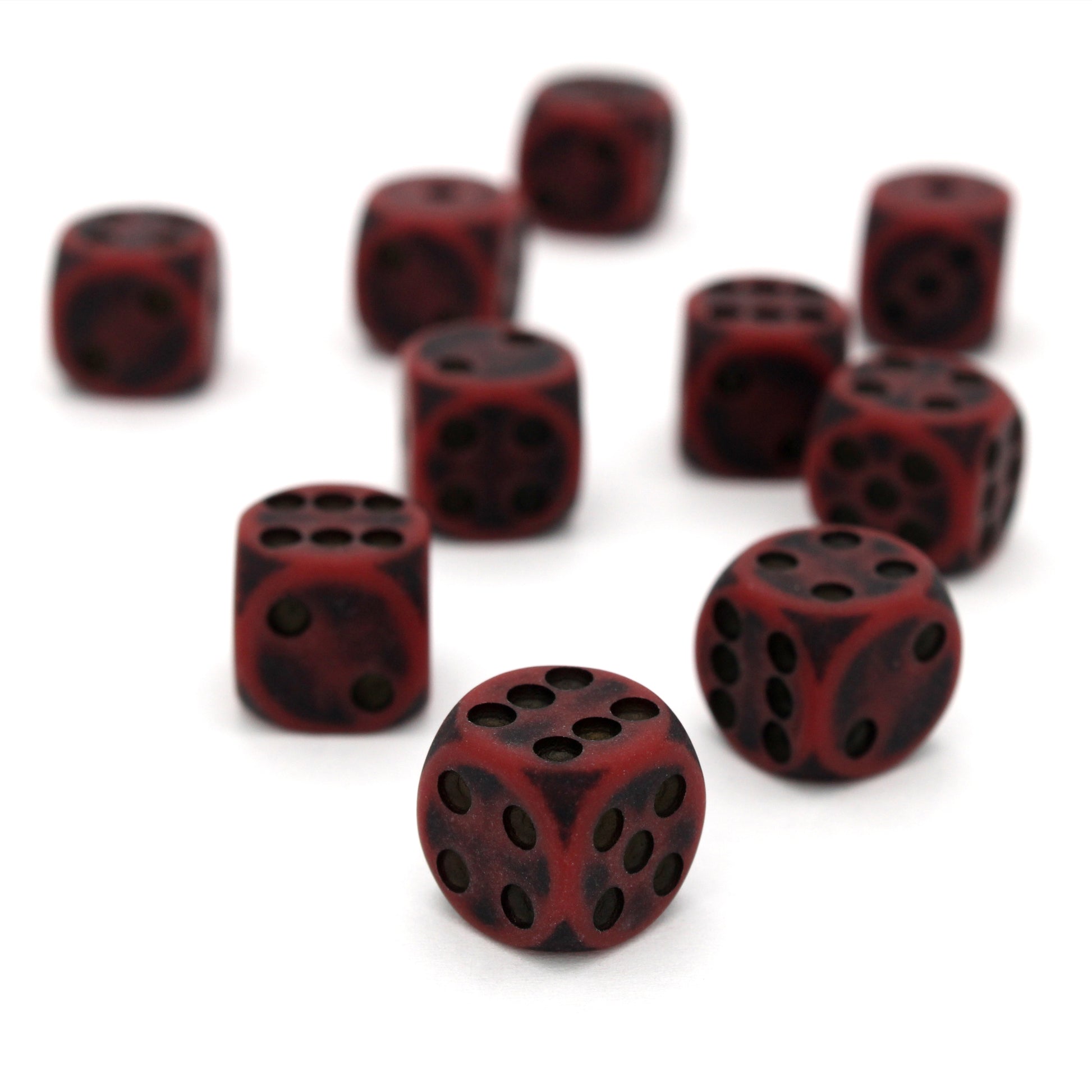 Orc Blood is a 10-piece set of dark red 12mm d6s, with pips inked in black.