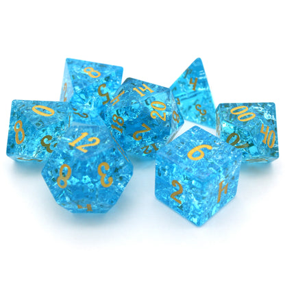 Pool Party is a 7-piece set of teal blue glass dice with a crackle effect and gold inked numbers.