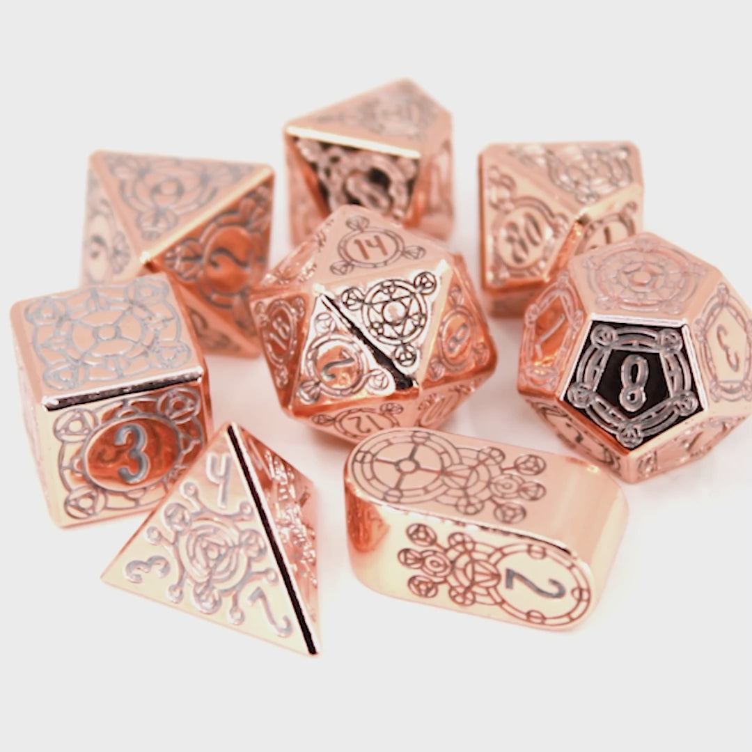 Sunlight Sigil is a Dice Envy Original 8-piece set of highly polished, rose gold metal dice in our Sigil mold, inked in silver.