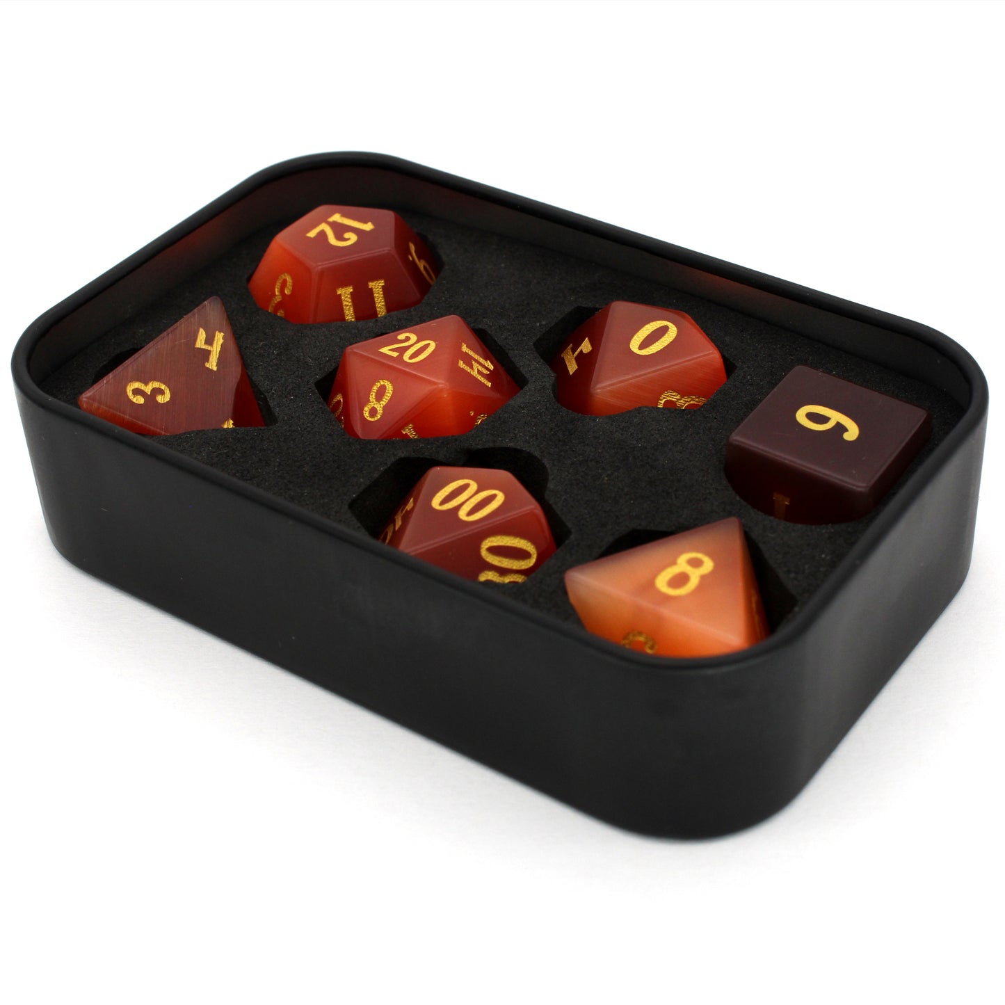 Pyromancer is a 7-piece set of orange cat's eye glass dice with gold numbering.