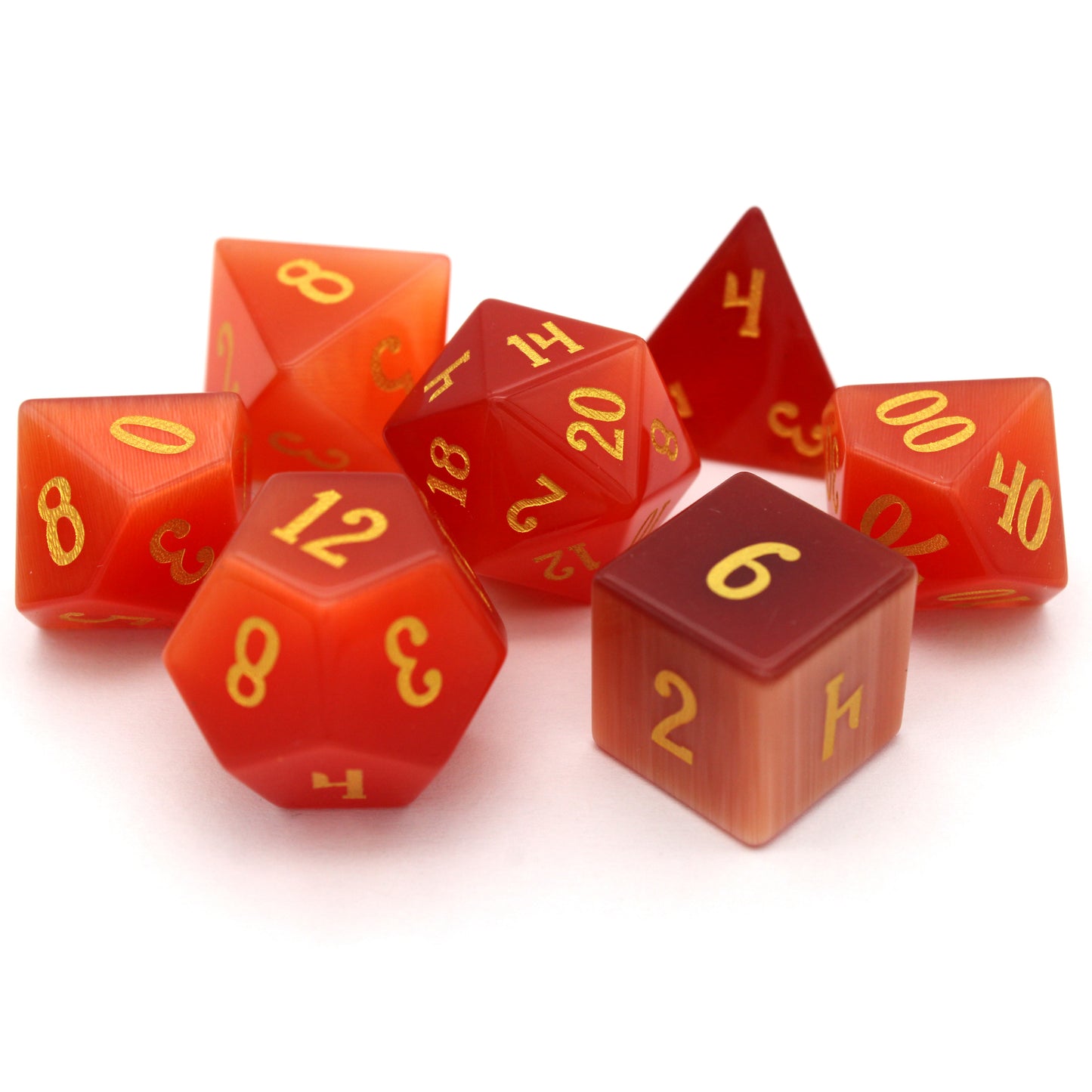Pyromancer is a 7-piece set of orange cat's eye glass dice with gold numbering.