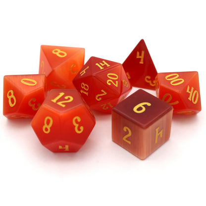Pyromancer is a 7-piece set of orange cat's eye glass dice with gold numbering.