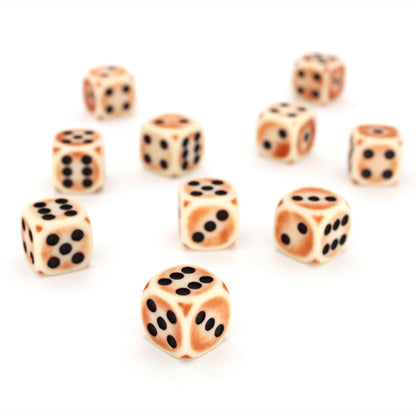 Rust Antennae is a 10-piece set of matte pale-colored 12mm d6s, with a rust patina, and pips inked in black.