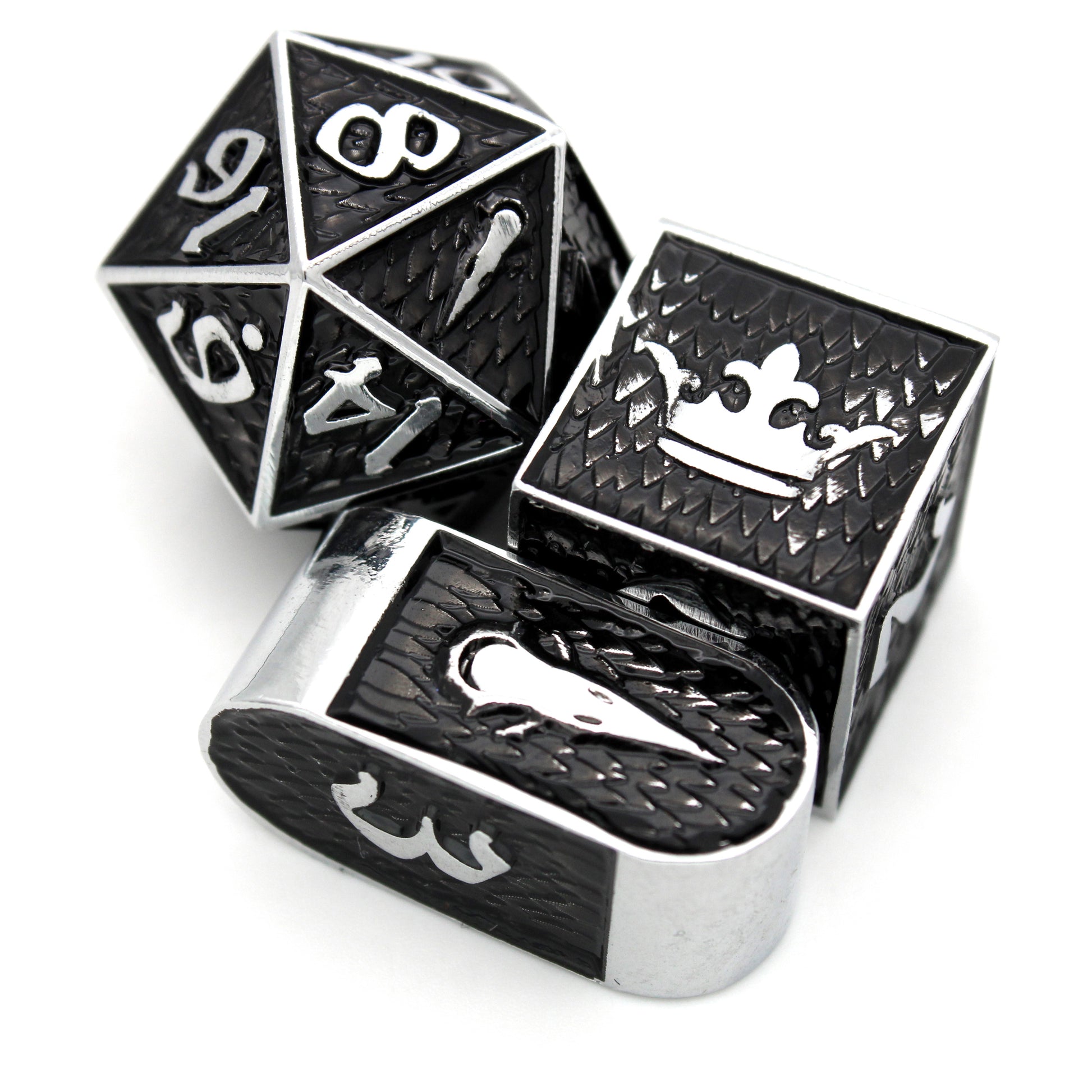 Shadowfell is an 8-piece Dice Envy Exclusive set of silver metal dice featuring raven imagery, cloaked in shadowy black ink.