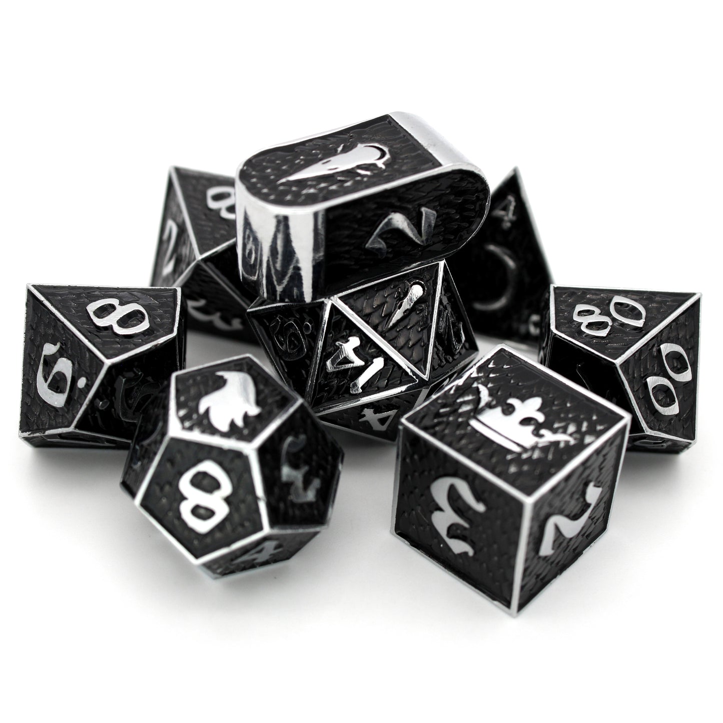 Shadowfell is an 8-piece Dice Envy Exclusive set of silver metal dice featuring raven imagery, cloaked in shadowy black ink.