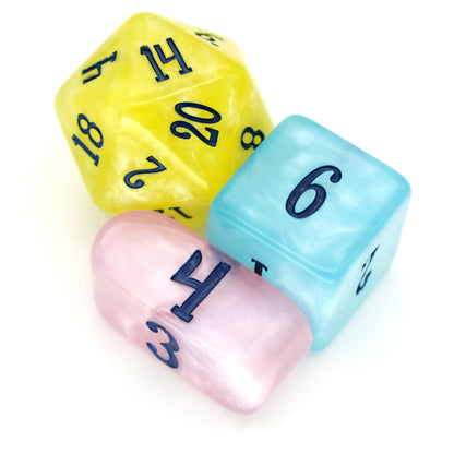 Shimmering Baubles is a 10-piece set of dice in shades of pastel rainbow, inked in dark blue.