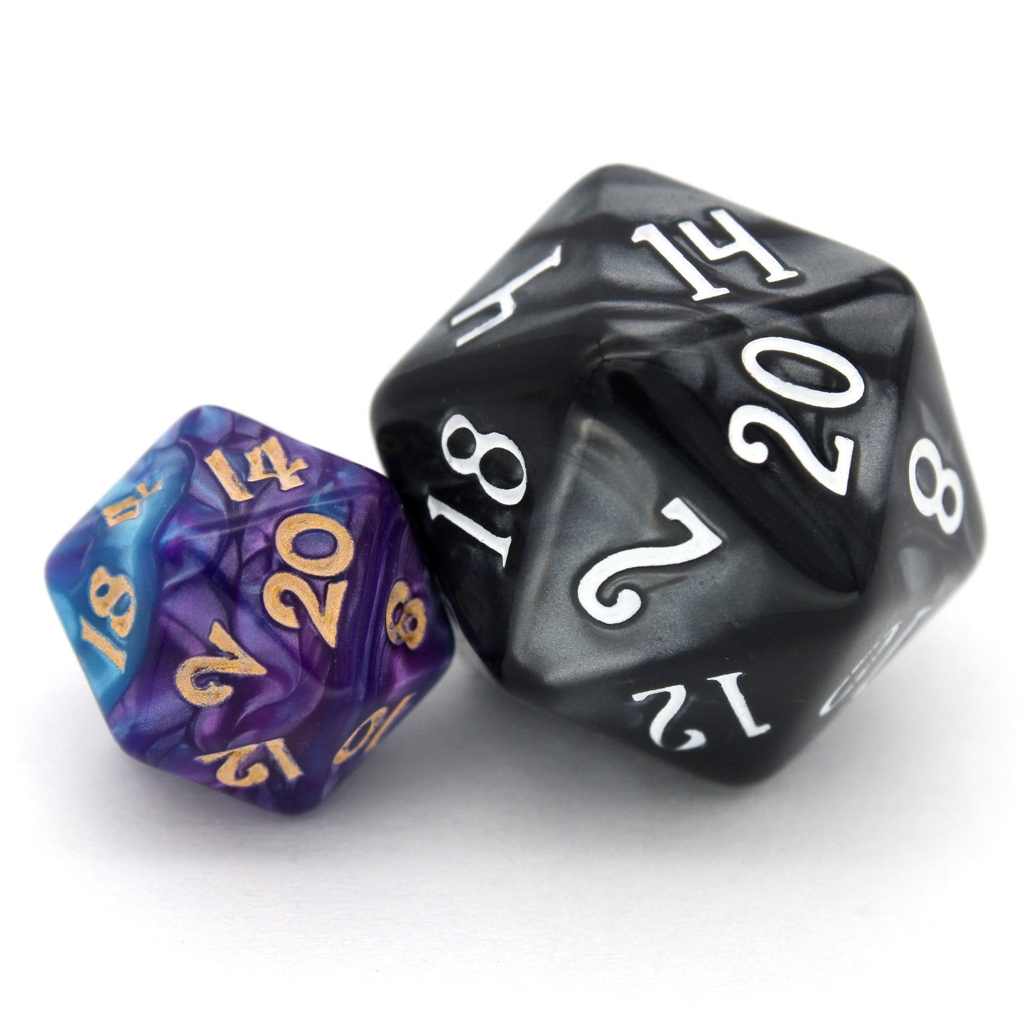 Sky Shadow is a 7-piece, 13mm polymer set of swirled blue and purple acrylic dice, inked in gold. It belongs to our tiny but mighty Wee Lads collection. Standard d20 pictured for scale.